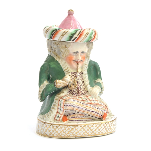 169 - A 19th century Staffordshire tobacco jar in the form of a seated Turk, 19.5cm high