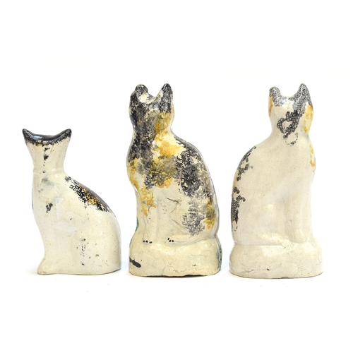 167 - Three early 19th century Staffordshire figures of cats with sponged decoration, 12cm high and 9cm (3... 