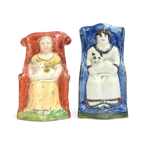 168 - Two unusual early 19th century Staffordshire pearlware figures of women sitting in armchairs each wi... 