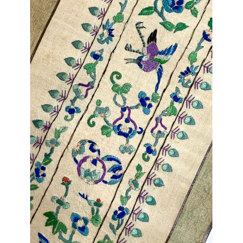 419 - A late 19th century Chinese silk embroidered sleeve band panel mounted on a scroll, embroidered with... 