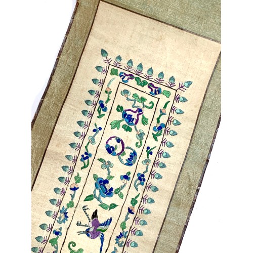 419 - A late 19th century Chinese silk embroidered sleeve band panel mounted on a scroll, embroidered with... 