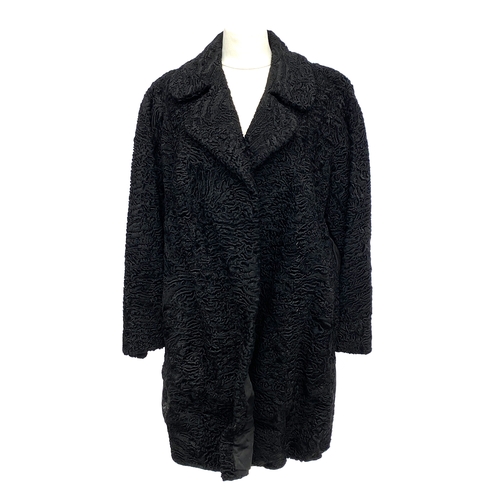 685 - A vintage 'Mister Monty Furs, Altrincham', black astrakhan coat with suede panel detail, 44