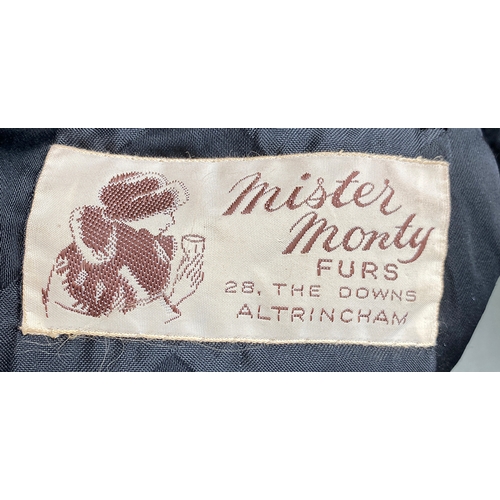 685 - A vintage 'Mister Monty Furs, Altrincham', black astrakhan coat with suede panel detail, 44