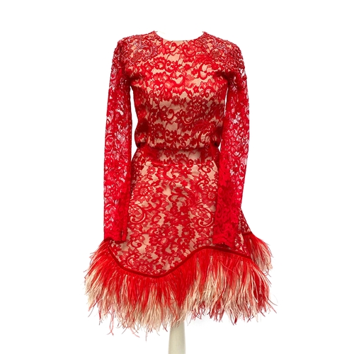 694 - A designer long sleeved dress, red lace with two tone ostrich feather trim, beaded detail to shoulde... 