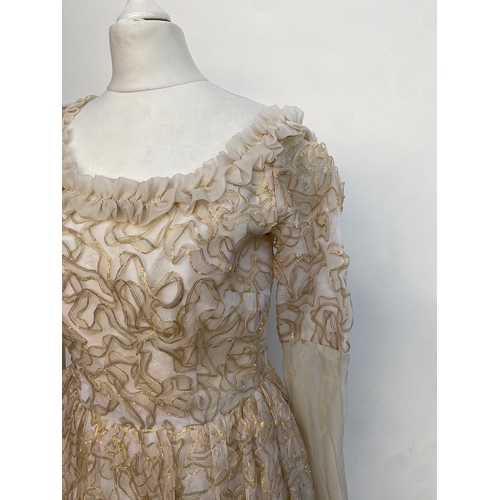 713 - A white silk and tulle dress worked with gold thread, approx. size 12

Provenance: from the wardrobe... 