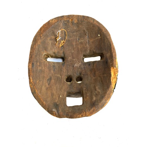 486 - A West African Ghana Ashanti tribal mask, with cowrie shell detail, 30cmW