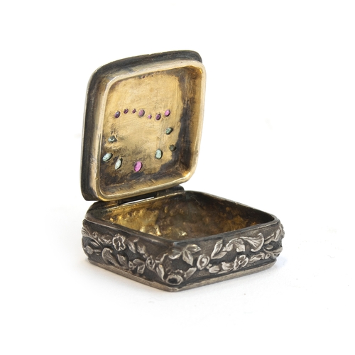 88 - A late 19th century small silver pill box, the lid decorated with a giardinetti style stand of flowe... 