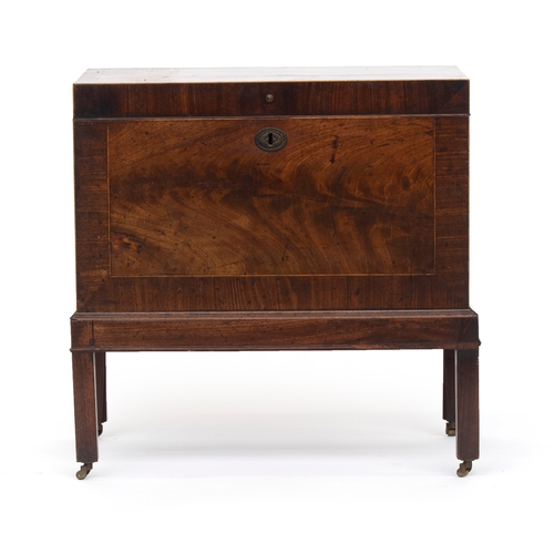 410 - A George III mahogany and cross banded cellarette, the interior subdivided, on a moulded base with s... 