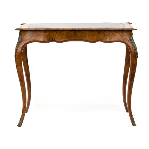 429 - A 19th century French walnut and cross banded writing table, the shaped top with tooled leather skiv... 