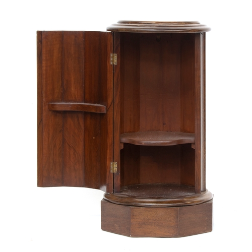 453 - A mahogany pedestal, in the form of a reeded column, the circular moulded top over a cupboard, on an... 