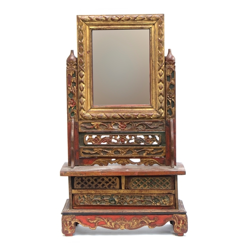 331 - An Indonesian dressing table mirror, red and gilt carved wood with pierced panel detail, 71cm high