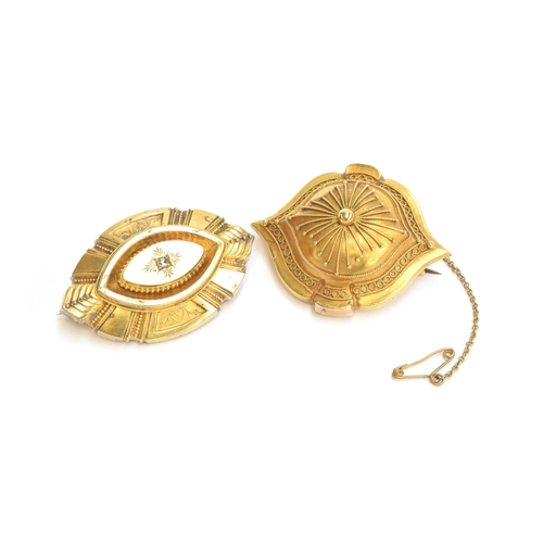 19 - Two Victorian Etruscan Revival gold brooches, both with locket backs, one set with a diamond chip, 4... 