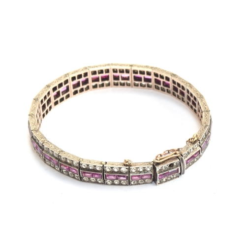 36 - An Art Deco 9ct white gold panel bracelet set with a central row of calibre cut rubies flanked by wh... 