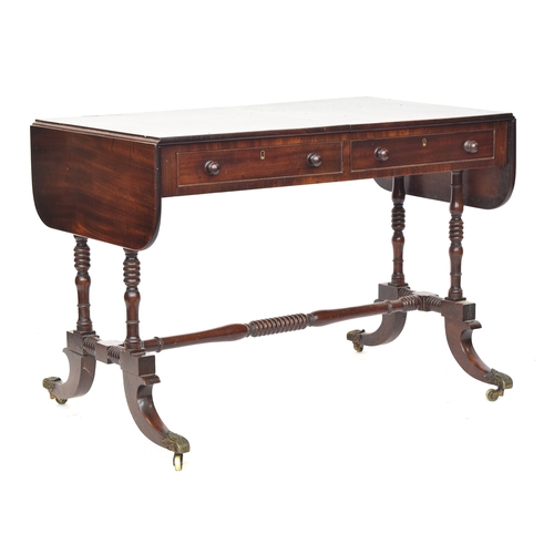 390 - A Regency mahogany sofa table, with two frieze drawers raised on ring turned supports joined by a ce... 