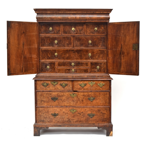 363 - An early 18th century walnut veneer cabinet on chest, the moulded cornice above a cushion frieze dra... 