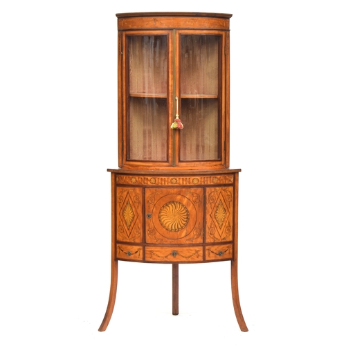 440 - An Edwardian bowfront glazed standing corner cupboard, glazed top, the base with marquetry and penwo... 