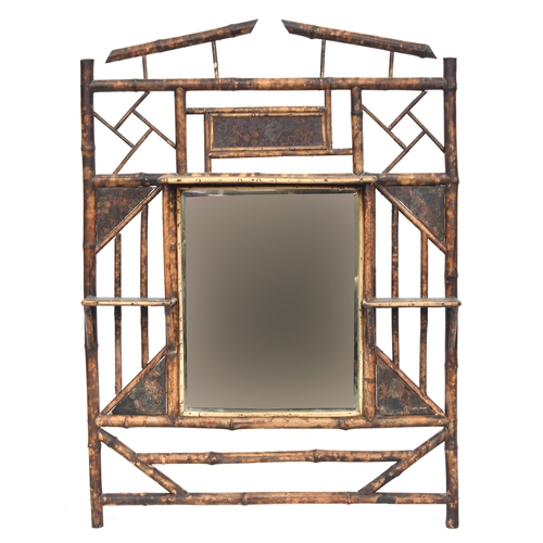 332 - A Victorian tiger bamboo hall mirror, with an arrangement of shelves around the central plate, 83cm ... 