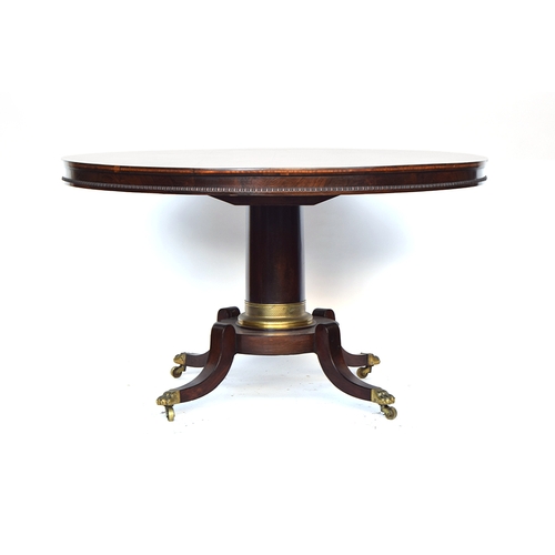 396 - A Regency rosewood circular tilt top breakfast table, on a plain turned column with gilt metal mount... 