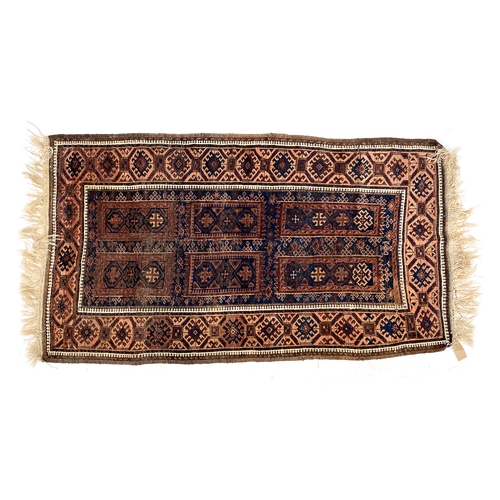 482 - An Afgan Baluch brown and blue ground rug with six central panels, 202x108cm