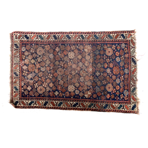 483 - A small Persian Qashqai rug, blue ground with profuse palmette and rosette pattern within a geometri... 