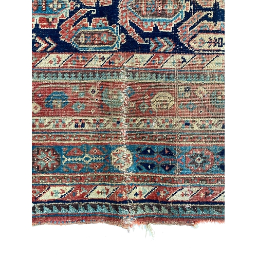 484 - A very long West Persian rug, the blue ground of boteh in a triple border, 555x220cm, some damage, e... 