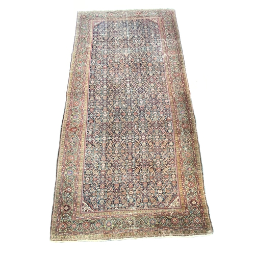 485 - A very large Persian rug with green border, 483x230cm