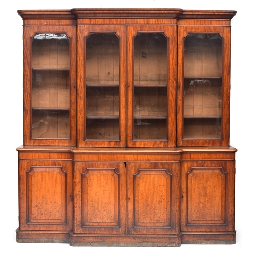 422 - A 19th century glazed breakfront bookcase, the moulded pediment over a four section glazed top, the ... 