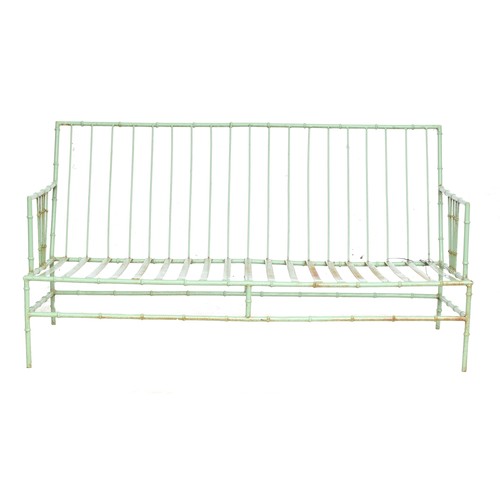 472 - A sage green painted wrought iron faux bamboo garden sofa, with cushions, 152cm wide

Provenance: fr... 