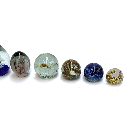 254 - A collection of 10 glass paperweights, to include Guernsey, Azurene glass, bubble glass etc, the tal... 