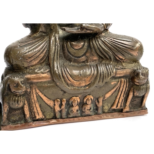 384 - An antique copper and brass amoghasiddhi Buddha, 20cmH; together with a smaller bronze buddha