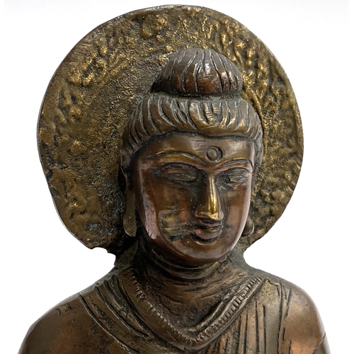 384 - An antique copper and brass amoghasiddhi Buddha, 20cmH; together with a smaller bronze buddha