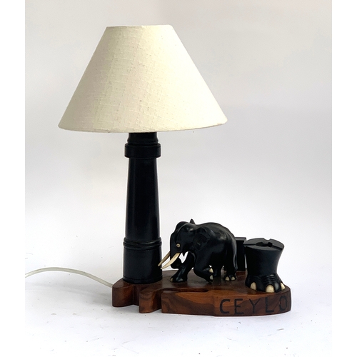 491 - A carved hardwood and ebony table lamp with elephant, 41cmH including shade