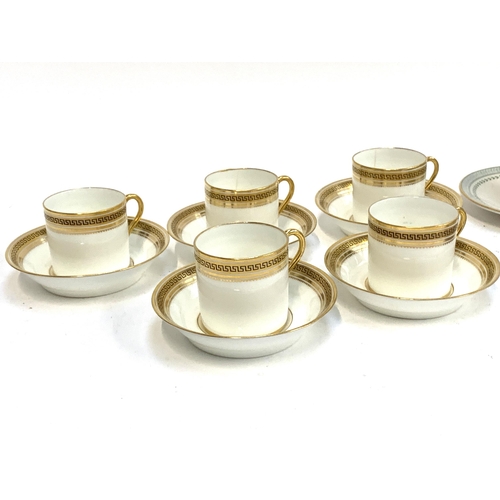 278 - A set of five smart early 20th century Cauldon coffee cans and saucers with gilt greek key pattern; ... 