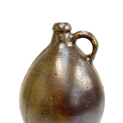 279 - An 18th century salt glazed stoneware flagon of ovoid form with loop handle, 40cmH