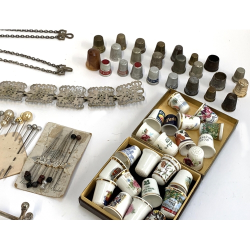 413 - A mixed lot to include silver plated belt; a collection of metal and ceramic thimbles to include Dor... 