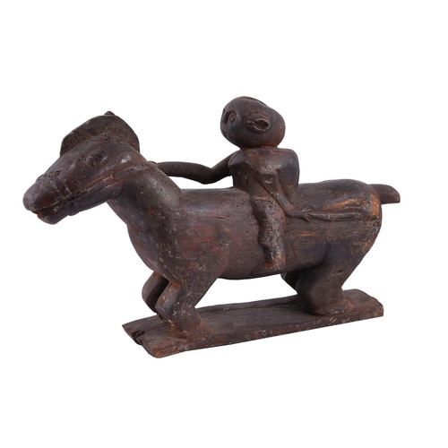 537 - A Timor carved wooden figure of a horse and rider