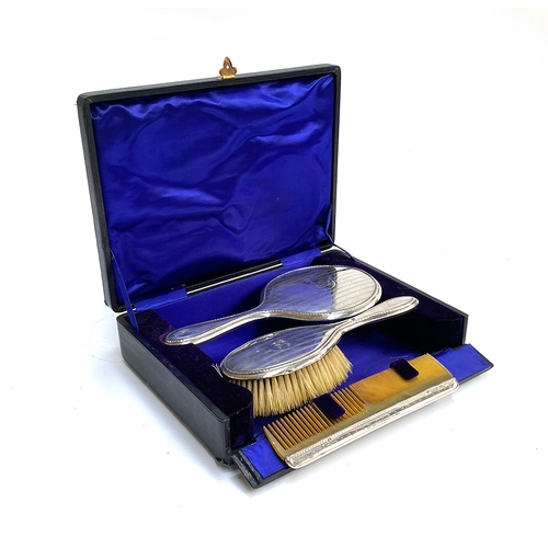 122 - A cased Edwardian vanity set comprising silver cased mirror, brush and comb, hallmarked for Birmingh... 