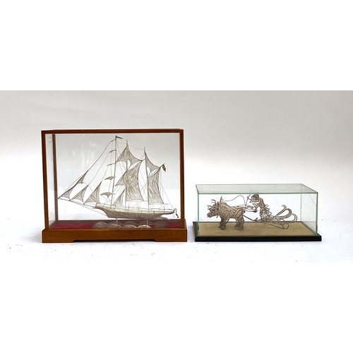 477 - A white metal filigree galleon in glazed display case, the case 22cmH; together with a similar white... 