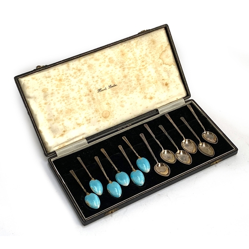 125 - A set of six silver and guilloche enamel coffee spoons; together with six further silver coffee spoo... 