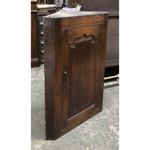 1203 - A George III oak corner cupboard, the door opening to three shaped shelves, 73x100cmH