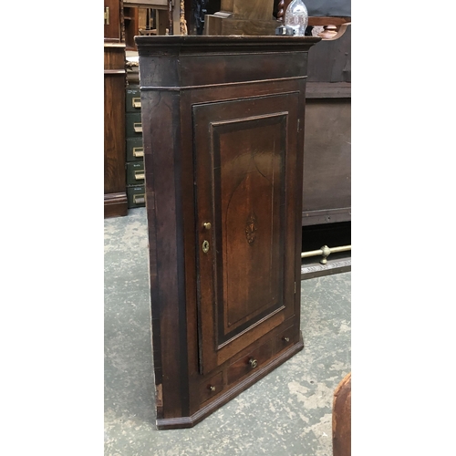 1227 - A George III oak corner cupboard, the door with applied moulding and central marquetry inlay and a s... 