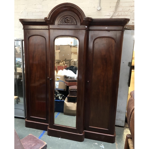 1252 - A Victorian mahogany three part gent's compactum wardrobe, with central mirrored section, approx. 19... 