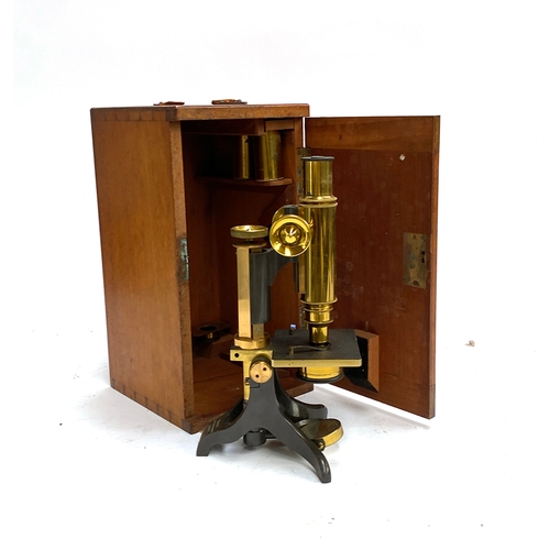 560 - A brass microscope in mahogany case, by Baker of High Holborn