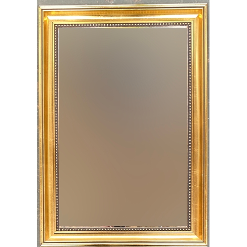 811 - A gilt framed wall mirror with bevelled glass, 78x55cm