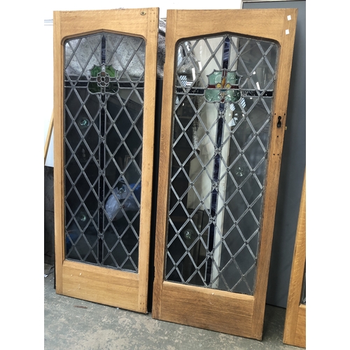 1262 - A set of four oak and lead glazed doors, each 74x200cm