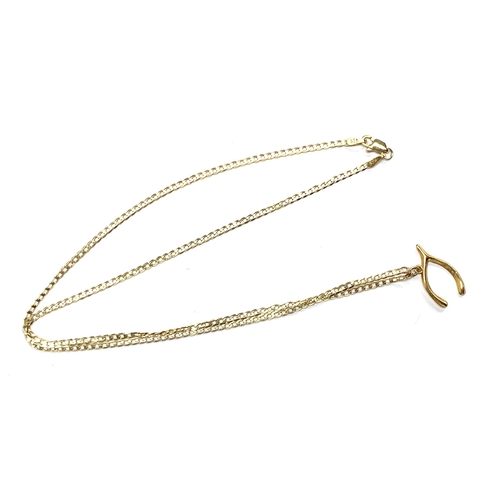 13 - A 9ct gold chain, 45cmL unclasped, with a 9ct gold lucky wishbone charm, 2cmW, gross weight 3g