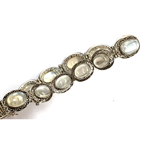 22 - A vintage silver bracelet set with moonstones in pierced floral panels, with safety chain, 14.9g