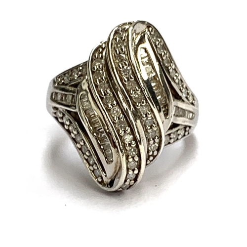 43 - A modern 925 silver ring set with baguette cut and brilliant cut diamonds, size N 1/2, 5.8g