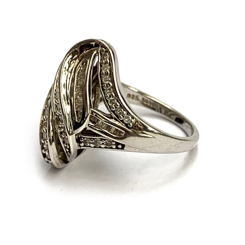 43 - A modern 925 silver ring set with baguette cut and brilliant cut diamonds, size N 1/2, 5.8g