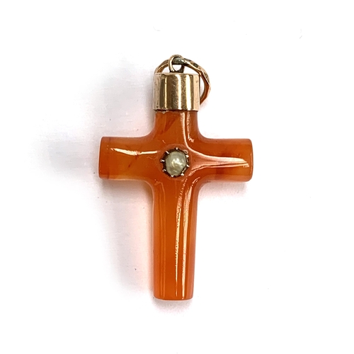 51 - A 19th century carved carnelian cross set with a split pearl, yellow metal capped, 1.8cm wide